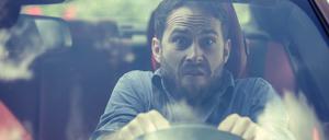 Stressed scared young man driver. Inexperienced anxious motorist concept