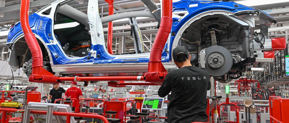 Ein Mitarbeiter vom Tesla-Werk Berlin Brandenburg arbeitet an einer Fertigungslinie für Elektrofahrzeuge vom Typ Model Y.