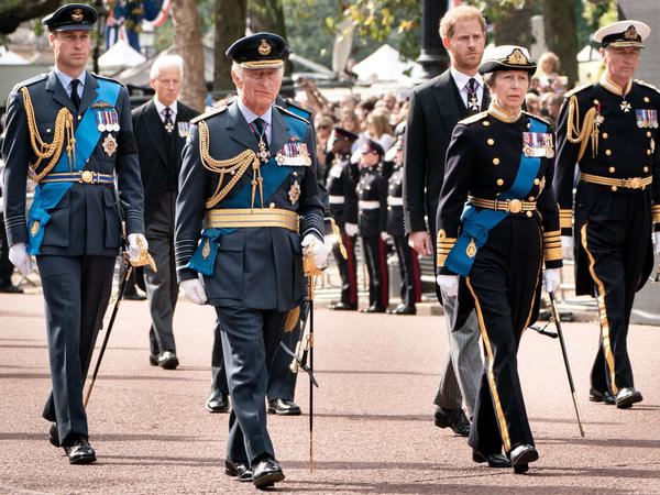 King Charles III  (front left), Prince Wiliam (back left) and Prince Harry (back center)