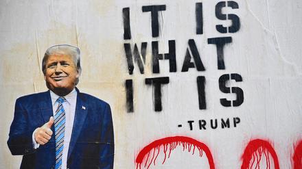 Street art picturing President Donald Trump and a phrase reading 'It IsWhat It Is' seen on October 2, 2020 in the Brooklyn borough of New York City. (Photo by Angela Weiss / AFP)