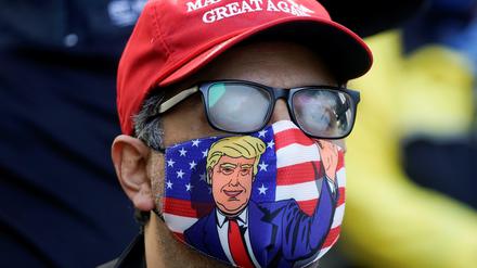 A supporter of U.S. president Donald Trump is pictured wearing a face mask and a ‘Make America Great Again’ cap as Trump supporters gather to demand a fair count of the votes of the 2020 U.S. presidential election, in Philadelphia, Pennsylvania, U.S., November 5, 2020. REUTERS/Eduardo Munoz     TPX IMAGES OF THE DAY