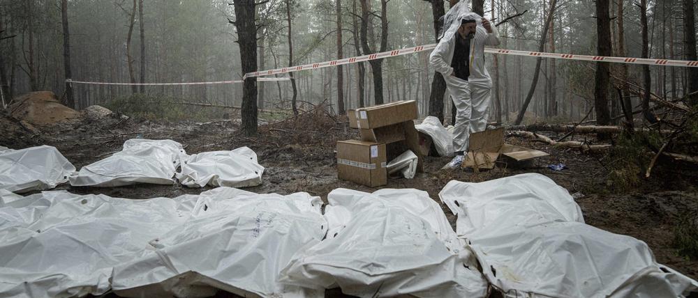 Säcke mit Leichen sind während der Exhumierung im kürzlich zurückeroberten Gebiet von Isjum, zu sehen. 