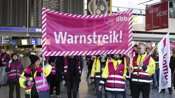 Streikende laufen mit Bannern durch das Terminal des Flughafens Frankfurt.
