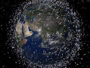 Das computergenerierte Bild der European Space Agency (Esa) zeigt Weltraummüll früherer Weltraummissionen, der neben intakten Satelliten um die Erde kreist. Im Orbit der Erde wird es immer voller. Metallteile schwirren um den Planeten und bergen Risiken für die Raumfahrt. Deshalb müssen sie entfernt werden.