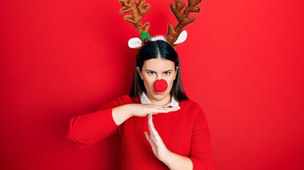 Junge Spanierin mit ernstem Gesichtsausdruck im Weihnachtskostüm.