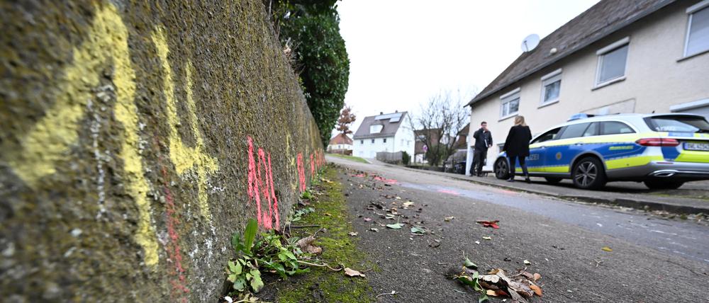 Markierungen der Spurensicherung der Polizei sind am Tatort auf einem Weg angebracht.