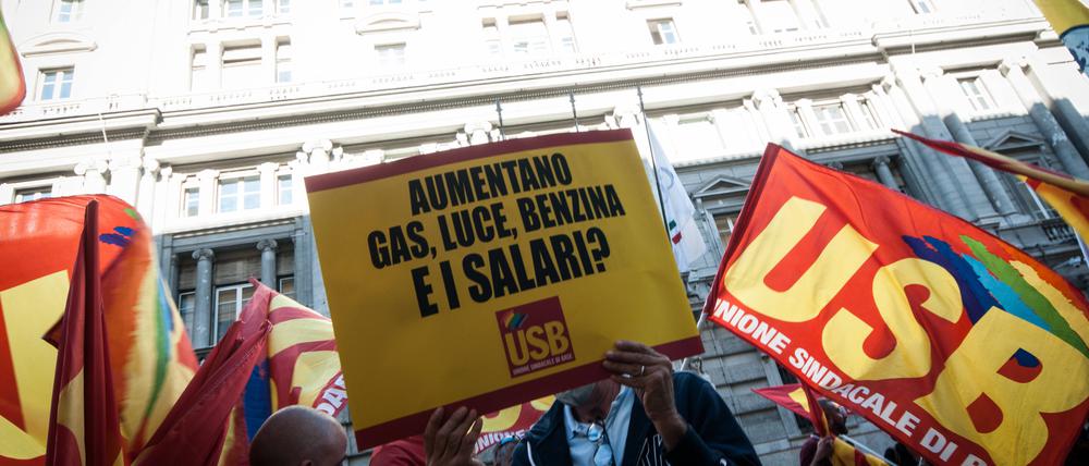„Die Preise für Gas, Licht, Benzin steigen. Und die Gehälter?“ steht auf dem Plakat eines Demonstranten am Montag in Rom.