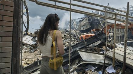 Eine junge Frau vor einem zerstörten Gebäude im ukrainischen Odesa
