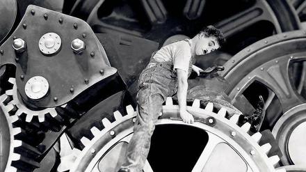 Multitasking. Früher malochte der Arbeitnehmer – hier Charlie Chaplin in „Modern Times“, 1936 – ohne Freizeitausgleich. Heute trifft das eher auf Arbeitgeber zu, Topmanager und Politiker müssen Workaholics sein.