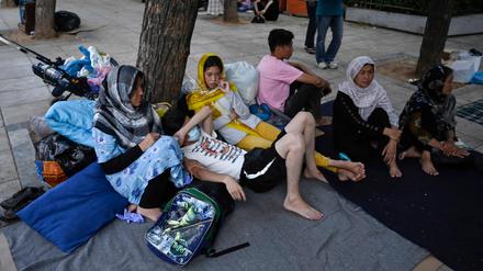 An Afghan family rests at Victoria square in central Athens, on July 29, 2020. - Around 100 mostly Afghan refugees have been camping in a square in recent days under temperatures exceeding 30 degrees Celsius (86 Fahrenheit) after arriving from island's camps. Refugees who were awarded asylum over a month ago, are allowed to leave Moria and other camps and sail to Athens, but without further assistance. "The camp authorities told us to leave Moria. But we were not told where to go, where to find assistance," a refugee says. (Photo by Louisa GOULIAMAKI / AFP)