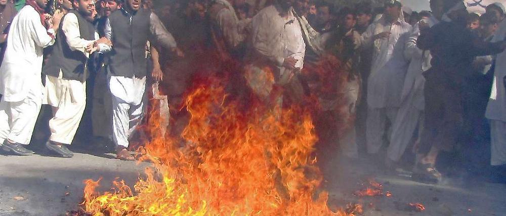 Als Reaktion auf eine Koran-Verbrennung in den USA verbrennen Demonstranten in Afghanistan eine US-Flagge. 