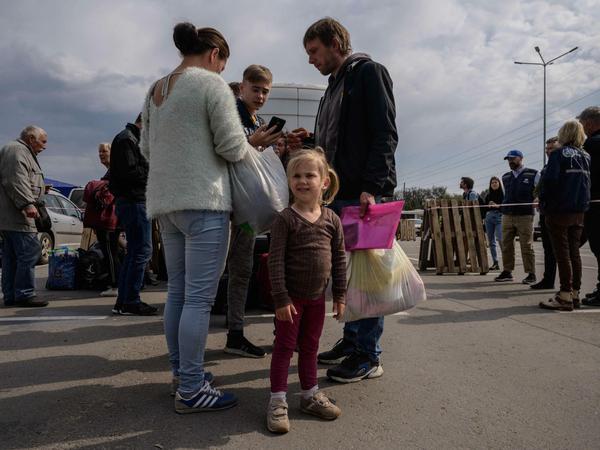 Eine Familie erreicht einen Registrierungsstand für Binnenflüchtlinge in der Ukraine.