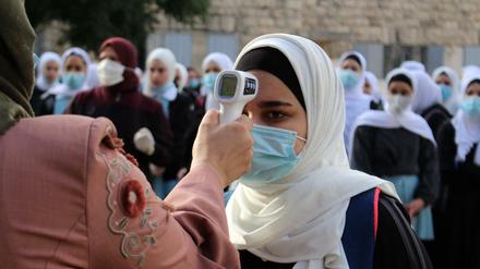 Prüfen, bitte! Bei einer palästinensischen Schülerin wird die Temperatur gemessen.