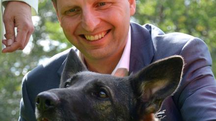 Justizsenator Thomas Heilmann (CDU) streichelt eine Schäferhündin der Rettungshundestaffel des Arbeiter-Samariter-Bundes. 