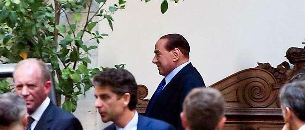 Silvio Berlusconi (hinten) am Freitag beim Verlassen seines Wohnsitzes in Rom.