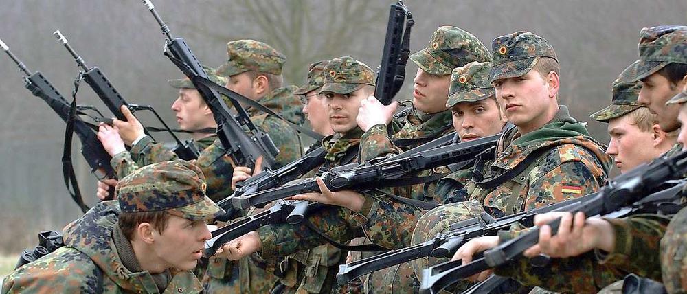 Ein Ausbilder der Bundeswehr überprüft auf einem Truppenübungsplatz in Ahlen die entleerten Waffen der Rekruten in der Grundausbildung.
