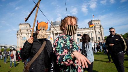 Teilnehmer mit einer Maske, Mund-Nasenschutz und Marionettengestänge demonstrieren zusammen mit mehreren hundert Menschen vor dem Reichstagsgebäude gegen eine Impfpflicht und gegen die Freiheitseinschränkenden Maßnahmen der Bundesregierung gegen die Ausbreitung des Coronavirus.