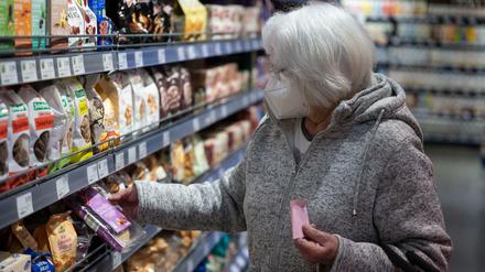 Eine Frau schützt sich in Göppingen beim Einkauf mit einer Maske.