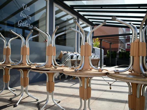Tische stapeln sich vor einer geschlossenen Eisdiele in Kassel.