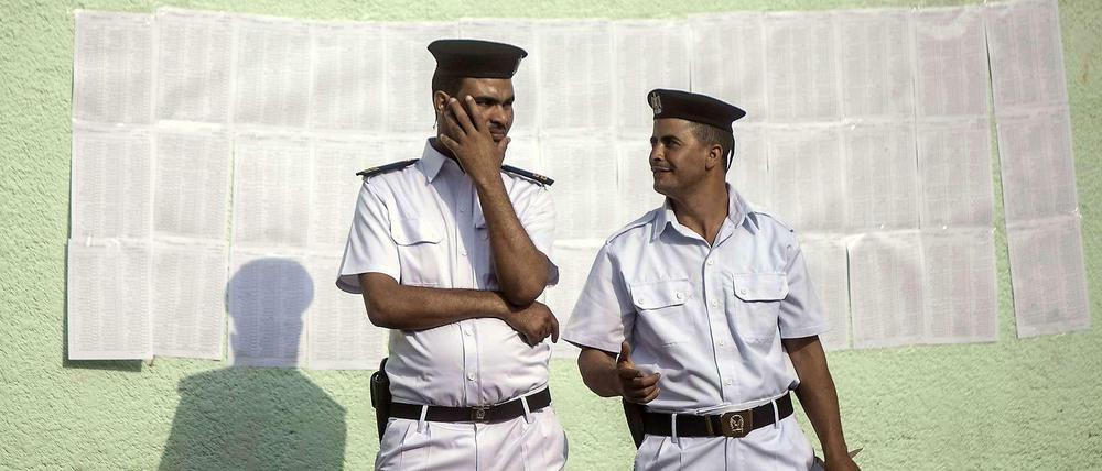 Zwei Polizisten vor einem Wahllokal. Hinter ihnen ist der Stimmzettel zu sehen. Er könnte kürzer sein, denn der Wahlsieger steht schon fest: General Abdel Fattah al Sisi wird der nächste Präsident Ägyptens sein. Die einzigen, die ihm Konkurrenz machen könnten, sind die Muslimbrüder, und die sind zur Wahl nicht zugelassen. 