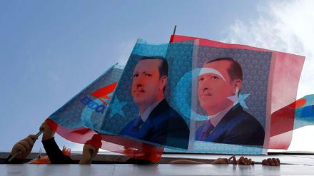 Auf dem Weg zu einer Kundgebung: Anhänger von Premier Erdogan halten Fahnen aus einem Boot.