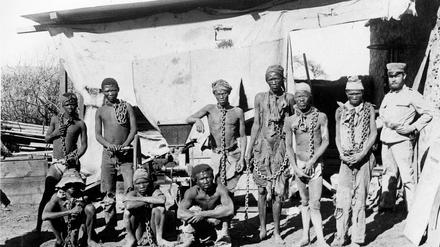 In Ketten gelegt oder in die Wüste geschickt: Ein deutscher Soldat in Südwest-Afrika (Namibia) mit Gefangenen der Herero und Nama.