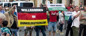 Mit Deutschlandfahnen "Willkommen in Dunkeldeutschland" und "Das Pack grüßt Gauck" wurde gegen Gauck protestiert.