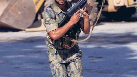 Unter Feuer. Ein Kämpfer der Freien Syrischen Armee bringt sich bei einem Angriff von Regierungstruppen nahe der Stadt Aleppo in Sicherheit. 