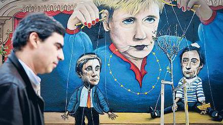 Ist Angela Merkel diejenige, nach deren Pfeife alle tanzen? Die portugiesische Protestbewegung zumindest hält ihre eigene Regierung für willfährige Marionetten.