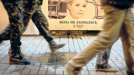 In Kiew gehen Menschen an einem Plakat mit dem Bild von Julia Timoschenko vorbei. 