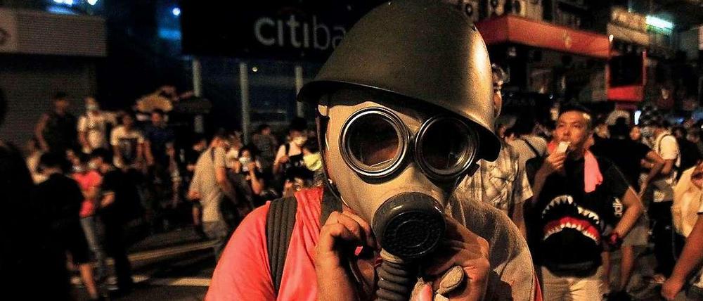 Demonstrant mit Gasmaske. In Hongkong gehen Zehntausende auf die Straße. Sie fordern mehr Demokratie und Rechtsstaatlichkeit.