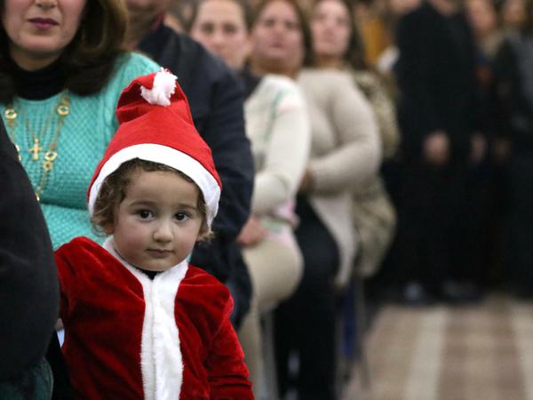 Auch verkleidete Kinder nehmen an einer Weihnachtsmesse in Bagdad teil.