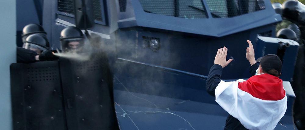 Sicherheitskräfte in Minsk setzen am 25. Oktober 2020 Tränengas gegen einen Demonstranten ein.