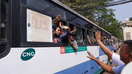 Festgenommene Demonstranten winken aus einem Bus, der aus dem Insein-Gefängnis kommt und sie zu einem ungenannten Ort transportieren wird.