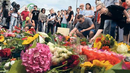 "Auch die Kommune mitten ins Herz getroffen" - Trauernde vor dem Olympia-Einkaufszentrum nach den Morden.