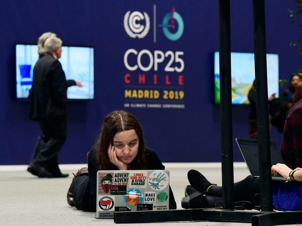 Kurze Pause: Eine Teilnehmerin liegt bei der Klimakonferenz in Madrid auf dem Boden