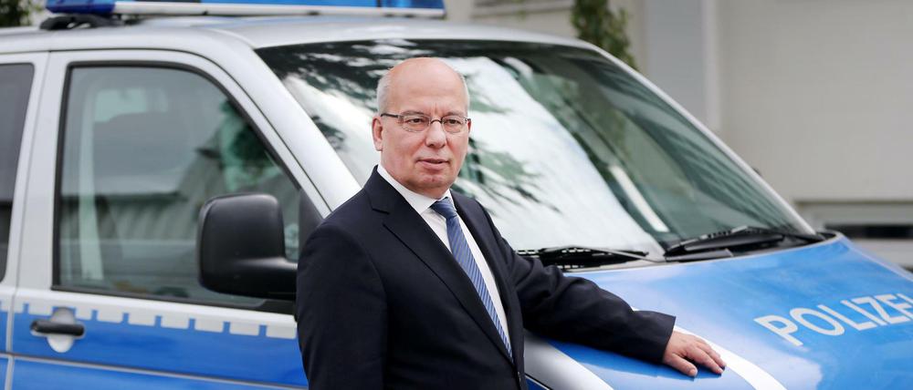 Der Bundesvorsitzende der deutschen Polizeigewerkschaft Rainer Wendt, der sich in der ARD-Vorabendserie "Rentnercops" selbst spielt, steht am 30. Juni 2016 in Köln (Nordrhein-Westfalen) in einer Drehpause an einem Polizeifahrzeug am Set.