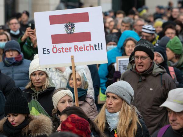 Teilnehmer einer Demonstration in Frankfurt halten ein Plakat mit der Aufschrift "Es Öster Reicht!!".