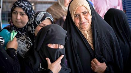 Iraqi women stand in line for relief. Every little space in the kurdish cities in Iraq are needed for refugees now. 