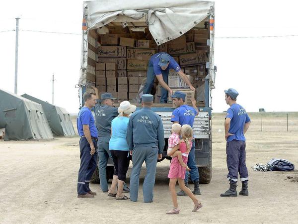 Flüchtlingslager in der Ostukraine: Von Moskau geschickte russische Helfer entladen einen Laster mit Hilfsgütern.