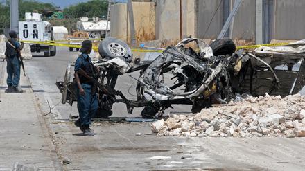 Somalische Soldaten am Wrack eines von einer Bombe zerstörten Autos in Mogadischu. 