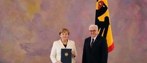 Angela Merkel mit der Ernennungsurkunde zu ihrer vierten Kanzlerschaft mit Bundespräsident Frank-Walter Steinmeier.