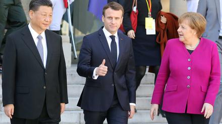 Annäherung an die Realität: Chinas Präsident Xi mit dem französischen Staatsoberhaupt Emmanuel Macron und Bundeskanzlerin Angela Merkel in Paris. 