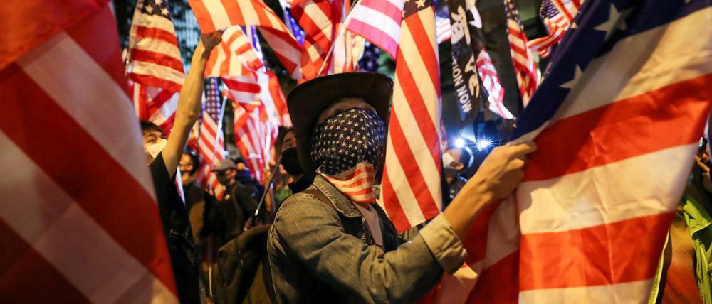 Mit US-Fahnen feiern Demonstranten in Hongkong die Unterstützung durch US-Präsident Trump. 