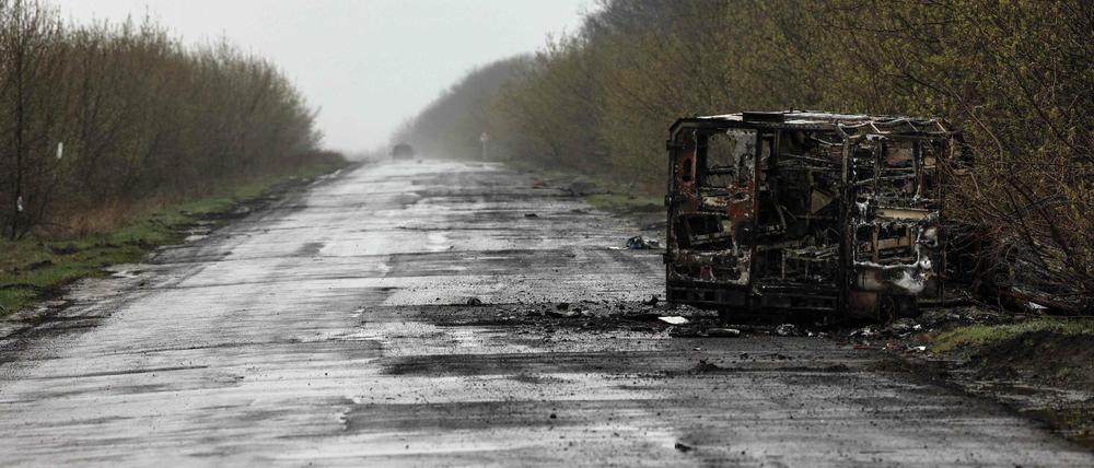 Ein ausgebrannter Van liegt auf einer Straße in der Donbass-Region.