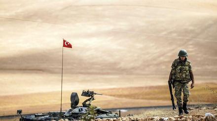 Türkischer Soldat patrouilliert neben einem Panzer an der Grenze zu Syrien