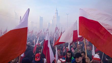 Mitglieder rechtsextremer Gruppen mit Fackeln und polnischen Flaggen beim Marsch zum Unabhängigkeitstag in Polen.