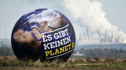 Ein Ballon mit der Aufschrift "Es gibt keinen Planet B." ist vor Braunkohlekraftwerken zu sehen. 