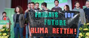 Schüler halten ein Transparent mit der Aufschrift "Fridays for Future Klima Retten!" auf dem Parteitag. Links neben dem Transparent steht die Potsdamer Schülerin Miriam Eichelbaum, am Pult Hannelore Wodtke.