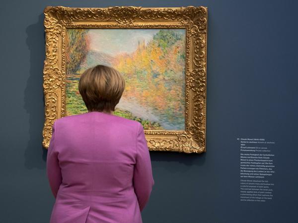 Bundeskanzlerin Angela Merkel (CDU) steht bei einem Rundgang anlässlich der offiziellen Eröffnung des Museums Barberini in Potsdam vor dem Gemälde "Herbst in Jeufosse" von Claude Monet. 